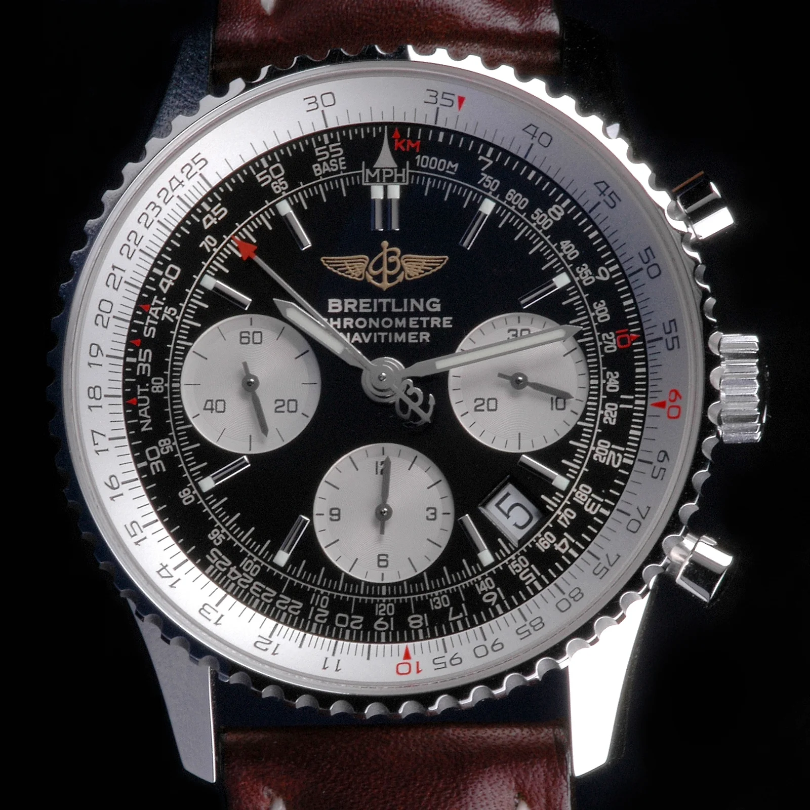 Chronograph Watch: A watch face with multiple sub-dials, pushers, a marked bezel, and dense small markings.