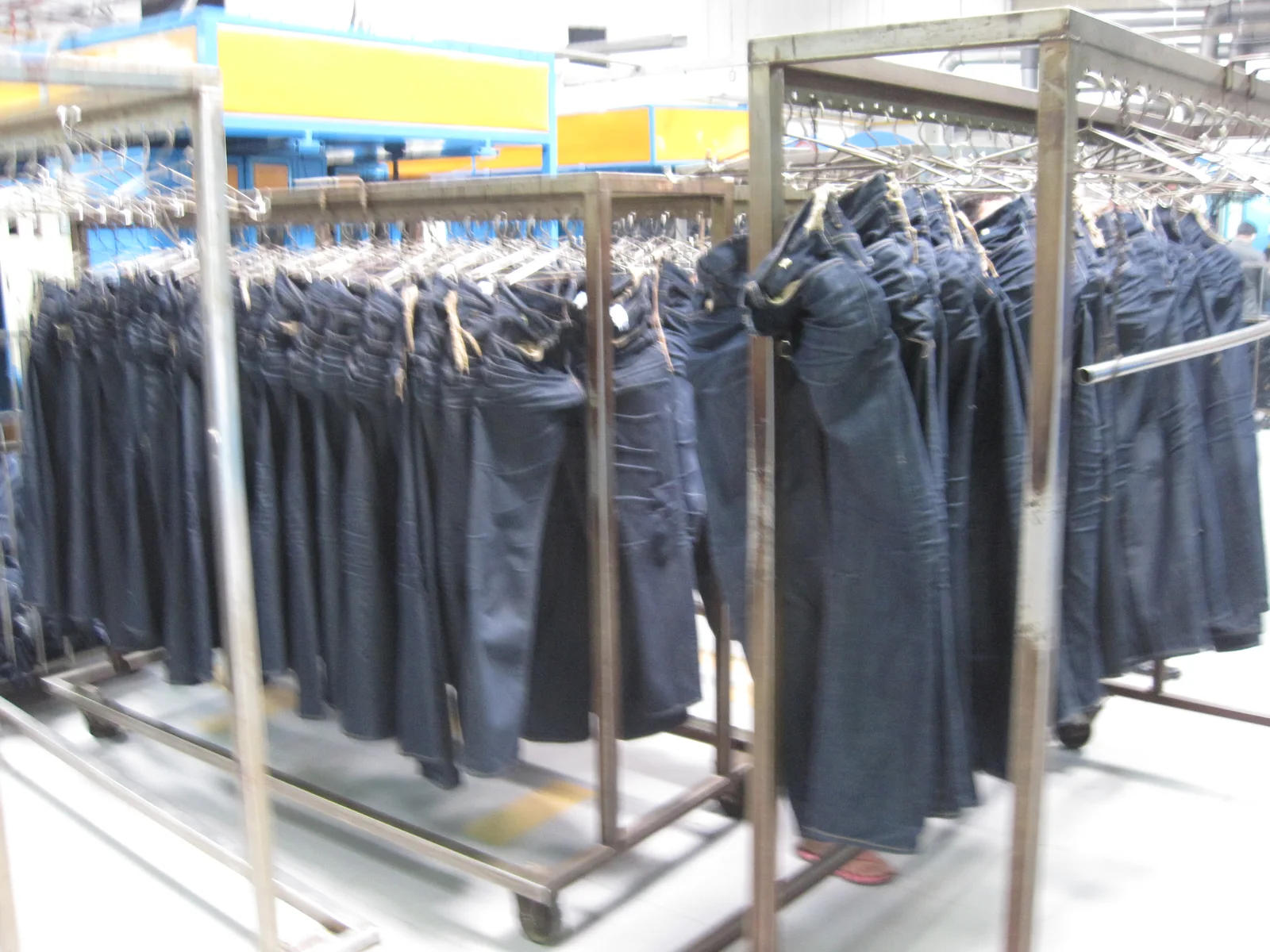 Five-Pocket Denim Jeans: Indigo denim trousers with five pockets, contrast stitching, rivets, belt loops, and shaped legs.
