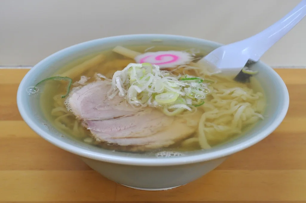 Japanese Ramen Bowl: A deep decorated bowl with a broad rim, noodles, broth, and layered toppings.