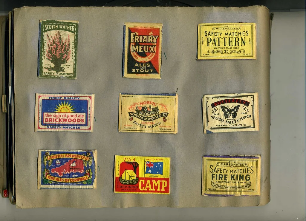 Matchbox Label: A small printed label with a compact image, brand lettering, border, and a field of colour.