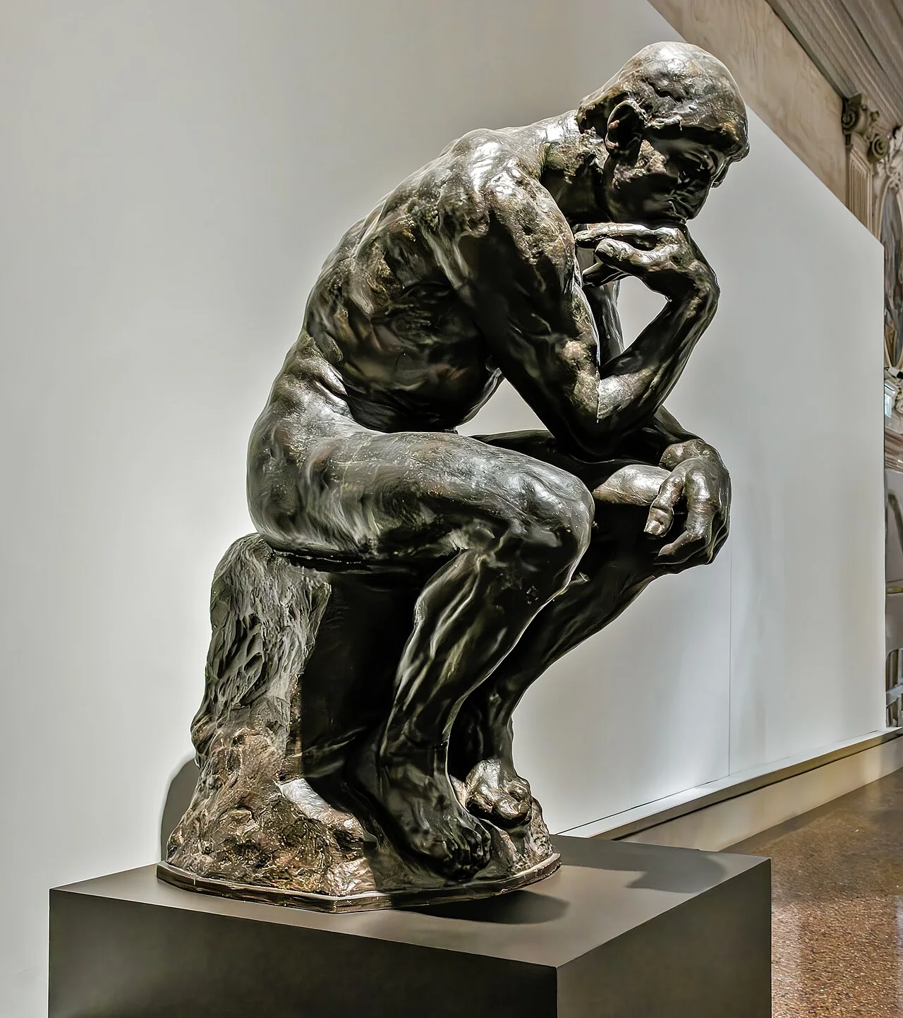 The Thinker: A seated muscular figure leaning forward with one hand supporting the chin.